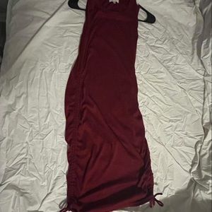 Red sleeveless dress. Knee length. Ties on side for scrunch option